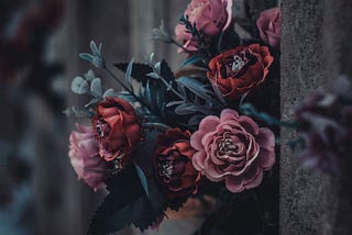 Pink and red roses placed on a gravestone