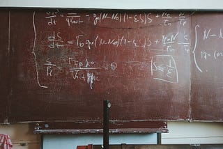 An old-fashioned blackboard with equations scribbled on it