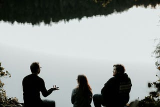 The people storytelling while sitting on a ledge.