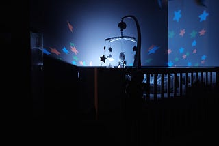 a crib at night, with stars glowing around