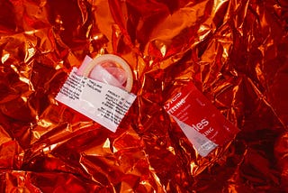 A picture of an opened condom still half in its wrapper.
