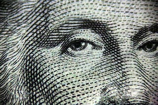 A close-up picture of George Washington on the one dollar bill.