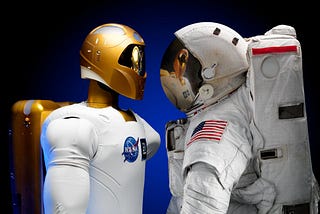 An image of two space suits facing each other. Robonaut, a human like robotic astronaut, on the left. A NASA human astronaut in a NASA space suite.