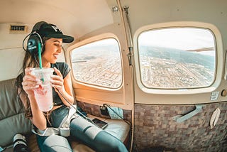 Woman in airplane listening to headphones