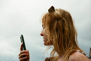 A woman looking directly at her phone