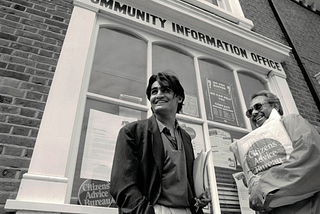 Two men standing outside a Citizens Advice office in the 1980s