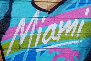 a mural in bright colors that says “Miami”
