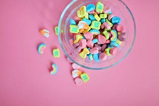 A bowl of Lucky Stars against a pink background