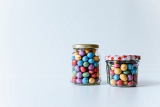 two jars with candles in them.