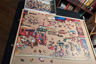 Picture of a partially assembled puzzle, with many disconnected sections