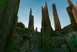 Alien landscape with dense green foliage, tall, point rock spires and large birds circling overhead