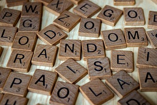 Scrabble pieces on a table spell random in middle