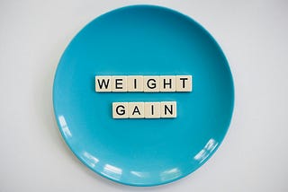 Blue plate with letters spelling weight gain