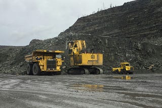 Yellow and black truck on road near mountain during daytime