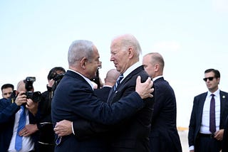 Israeli Prime Minister Benjamin Netanyahu (L) greets US President Joe Biden upon his arrival at Tel Aviv’s Ben Gurion airport on October 18, 2023