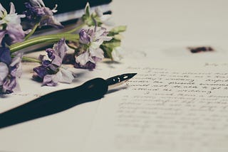 A half-finished letter with a pen lying beside it.