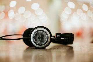 Black headphones on a sparkly backdrop