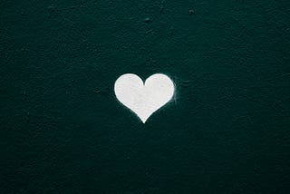 Small white heart shape with dark teal background