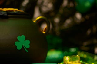 shamrock, golden beverage, leprechaun hat evoking a St. Patrick’s day party