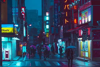 people under umbrellas on a busy, night-time, city street
