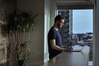 Man typing on his laptop at home