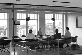 Group of people at a table in a conference room