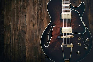 Electric Guitar hanging on a dark wall…