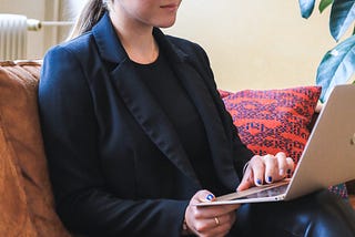 Women looking a computer with ad from woman wholesaler trying to sell a house