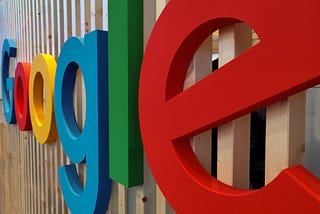 The Google sign on a wooden building.