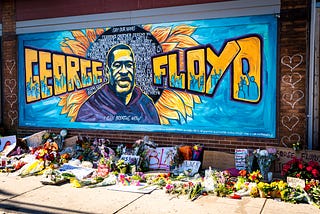 george floyd mural with flowers donated in memoria