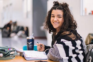 Girl sitting at a desk, smiling