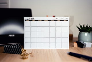 And empty paper calendar of whatever month, with nothing posted on it, on top of a desk