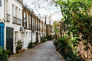 A cobblestone street of Victorian-era houses