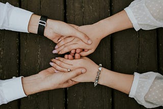Two people holding hands over a table