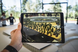 Tablet showing an augmented reality representation of a building in the shape of a circle