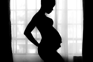 Pregnant woman in shadow