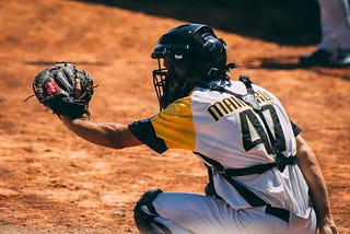 A baseball player with a baseball glove waiting to catch a ball