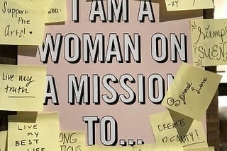 Board with the text “I am a woman on a mission to” with post-it notes describing her different missions.