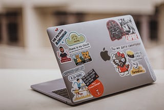 Laptop with stickers. What does a Product Manager do? The skills you need to build to become a Product Manager. Photo by Lala Azizli on Unsplash