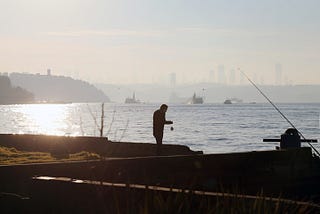 A Man Is fishing by hook. It is a great example of “The Definite Solution To The Complete Man Is Freedom of Time: How To Achieve It?”