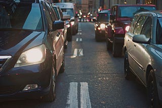 looking between two rows of cars on a city street