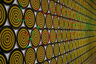 Hundreds of dart boards aligned in several rows.