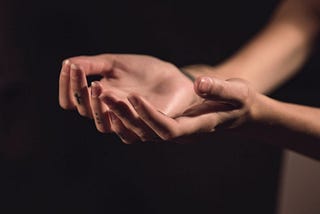 two hands held in a gesture of surrender
