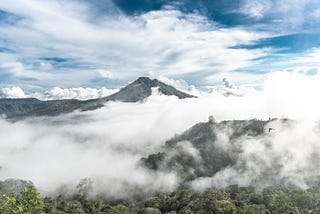 A mountain surrounded by mist and brilliant light