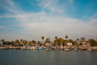 a harbor filled with lots of boats under a blue sky