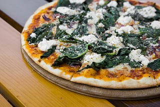 Pizza topped with spinach
