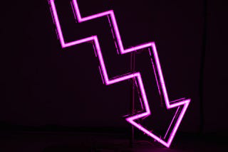A neon zig-zag arrow pointing to the bottom right