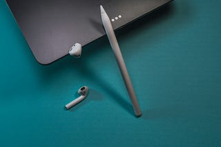 An Apple Pencil, iPad, and Airpods