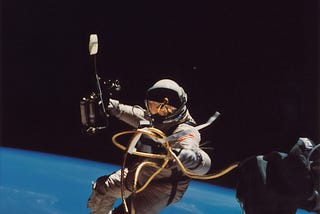 An astronaut leaving the limited world of her personal computer behind, and embarking on a journey to the virtual machine.