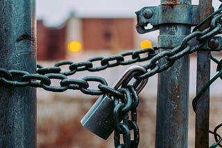 Picture showing a padlock on a fence.